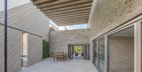 concrete ceiling,exposed concrete,dunes house,reinforced concrete,folding roof,concrete construction,structural plaster,natural stone,almond tiles,archidaily,stucco wall,daylighting,sand-lime brick,lattice windows,concrete wall,cubic house,stucco frame,stucco,concrete slabs,residential house