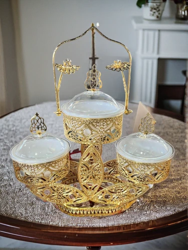 cake stand,persian new year's table,candlestick for three candles,eucharistic,gold foil crown,tablescape,gold chalice,tea service,dinnerware set,table setting,place setting,tea set,golden candlestick,persian norooz,dining table,table arrangement,centrepiece,dining room table,set table,beer table sets