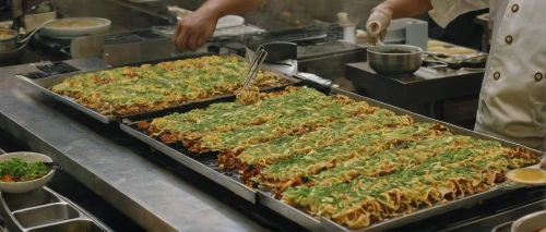 okonomiyaki,cress bread,hamburger fries,lahmacun,friench fries,food processing,murtabak,assembly line,yakisoba,hash browns,tlacoyo,sheet pan,friesalad,latkes,fried noodles,gallo pinto,serving tray,california maki,soba,kabab koobideh,Photography,Documentary Photography,Documentary Photography 32