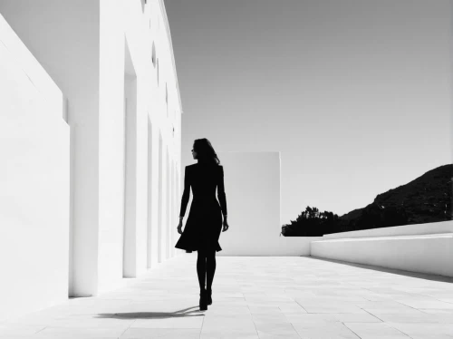 getty centre,woman walking,woman silhouette,girl walking away,white room,blackandwhitephotography,mannequin silhouettes,women silhouettes,walkway,white buildings,monochrome photography,whitespace,black-and-white,vanishing point,black coat,minimal,architect,black and white pieces,vertigo,silhouette against the sky,Illustration,Black and White,Black and White 33