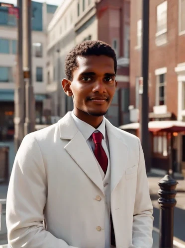a black man on a suit,black businessman,mohammed ali,real estate agent,african businessman,muhammad ali,business man,white coat,black professional,african american male,suit actor,sales man,white-collar worker,businessman,estate agent,yemeni,black male,men's suit,afroamerican,pharmacist