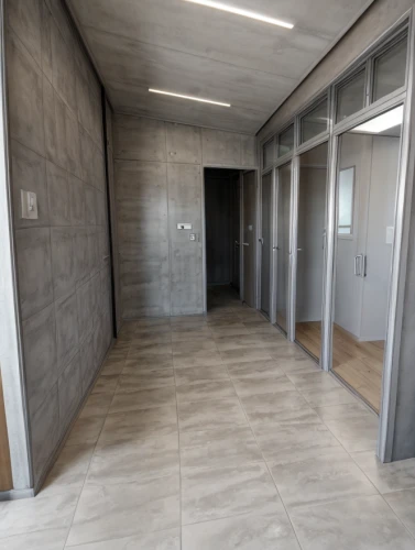 hallway space,wall completion,concrete ceiling,walk-in closet,tile flooring,exposed concrete,sliding door,hallway,structural plaster,recessed,core renovation,ceramic floor tile,flooring,daylighting,room divider,assay office,search interior solutions,wall plaster,washroom,tiling