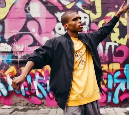 novelist,hip-hop,hip hop,hip-hop dance,hip hop music,rocky,fitzroy,rapper,rap,pointing,windbreaker,farro,hand pointing,mamba,icon,hiphop,raf,yellow brick wall,yellow jacket,yellow background