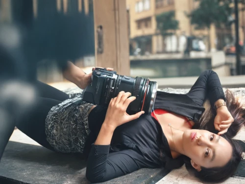 woman holding a smartphone,a girl with a camera,photo shoot on the floor,young model istanbul,birce akalay,on the phone,lazing around,woman laying down,woman sitting,photographer,woman drinking coffee,the girl is lying on the floor,taking photos,taking photo,holding shoes,black shoes,camera photographer,lying down,woman playing,victoria smoking