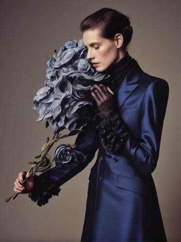 blue rose,woman in menswear,mazarine blue,menswear for women,blue rose near rail,formal gloves,holding flowers,with roses,with a bouquet of flowers,fabric flowers,flower arranging,gothic fashion,overcoat,artificial flowers,fabric flower,showpiece,shoulder pads,imperial coat,black coat,scent of roses,Photography,Fashion Photography,Fashion Photography 08