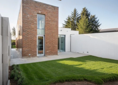 artificial grass,sand-lime brick,modern house,prefabricated buildings,cubic house,wheat germ grass,exposed concrete,residential house,quail grass,house hevelius,brick grass,grass roof,paved square,ruhl house,landscape designers sydney,heat pumps,core renovation,smart house,stucco wall,exzenterhaus