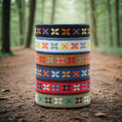 prayer wheels,container drums,flower pot holder,wooden drum,reed belt,washi tape,memorial ribbons,field drum,colorful bunting,round tin can,pattern stitched labels,wooden flower pot,paint cans,belts,traditional patterns,coffee cup sleeve,djembe,wooden spool,wooden barrel,patterned labels