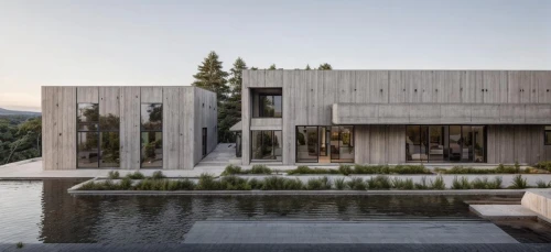 modern house,exposed concrete,modern architecture,dunes house,concrete construction,timber house,residential house,concrete blocks,cubic house,archidaily,cube house,residential,concrete slabs,reinforced concrete,house by the water,house in the mountains,concrete,private house,mirror house,flat roof,Architecture,General,Modern,Alpine Expressionism