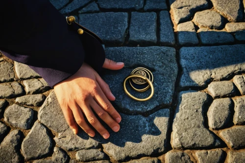 cobblestone,cobblestones,golden ring,gold rings,gold bracelet,paving stone,curb,wedding band,the cobbled streets,wedding ring,cobble,cobbles,mobile sundial,gold watch,letter chain,offering,cordwainer,paving stones,gold jewelry,tie shoes,Photography,Documentary Photography,Documentary Photography 14