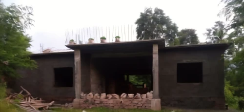 charcoal kiln,outdoor structure,dog house,nonbuilding structure,brick-kiln,a chicken coop,dilapidated building,pigeon house,kitchen block,build by mirza golam pir,traditional building,model house,grass roof,cooling house,abandoned building,pizza oven,wooden sauna,wooden hut,wooden construction,residential house