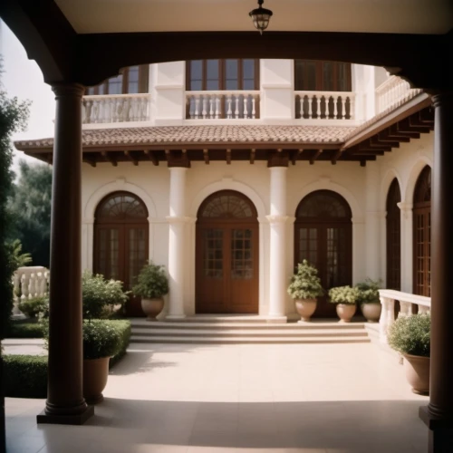 house entrance,stucco frame,gold stucco frame,exterior decoration,porch,hacienda,stucco wall,the threshold of the house,model house,patio,front door,garden elevation,spanish tile,pergola,inside courtyard,beautiful home,courtyard,house front,clay tile,florida home
