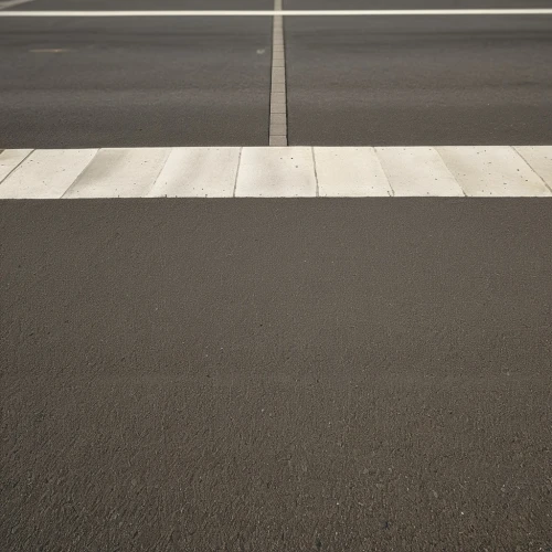 road surface,crosswalk,pedestrian crossing,taxiway,paved square,asphalt,tarmac,lanes,road marking,empty road,parking space,intersection,bus lane,pavement,one-way street,car park,parking lot,paved,crossroad,racing road,Photography,General,Realistic