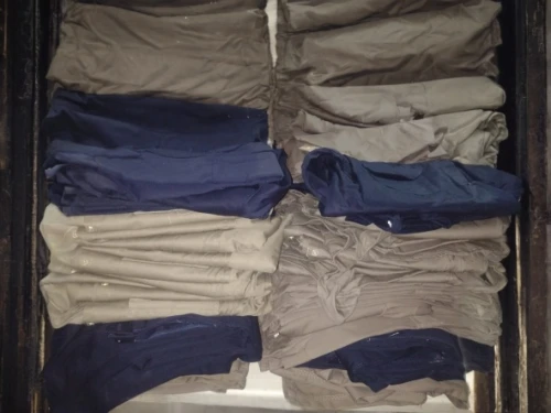 steamer trunk,a drawer,luggage compartments,wardrobe,packing,khaki pants,compartments,suit trousers,collection of ties,garment racks,old suitcase,clotheshorse,a uniform,packed up,suitcases,ammunition box,closet,chef's uniform,linen,clothes