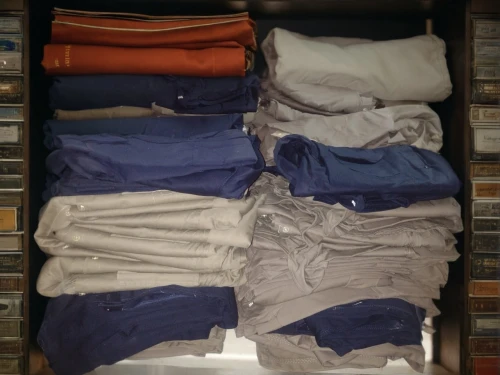 a drawer,polo shirts,wardrobe,garment racks,closet,linen,men clothes,walk-in closet,drawer,clothes,khaki pants,drawers,clothing,men's wear,clotheshorse,collection of ties,organized,suit trousers,steamer trunk,shirts