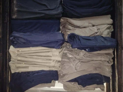 a drawer,wardrobe,packing,steamer trunk,suit trousers,khaki pants,compartments,linen,collection of ties,drawer,luggage compartments,polo shirts,closet,clotheshorse,clothes,shirts,clothing,men clothes,garments,packed up