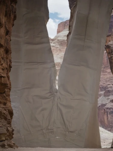 rock arch,arches,three point arch,natural arch,half arch,free solo climbing,guards of the canyon,three centered arch,rock formation,sandstone wall,hoodoos,el arco,crevasse,arches national park,sandstone,round arch,cargo pants,pants,loose pants,pillars