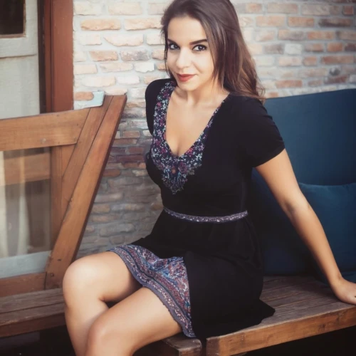 sitting on a chair,sitting,black dress,nice dress,crossed legs,short dress,vintage dress,dress,floral dress,little black dress,retro woman,legs crossed,black skirt,romantic look,pencil skirt,polka dot dress,skirt,attractive woman,in a black dress,latina