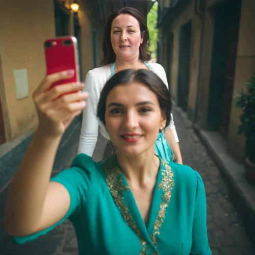 woman holding a smartphone,taking picture with ipad,family taking photos together,mobile camera,selfie stick,photobombing,women in technology,video call,taking picture,blogs of moms,the integration of social,social,the girl's face,taking photo,taking photos,portrait photographers,mom and daughter,social media addiction,moms entrepreneurs,video chat