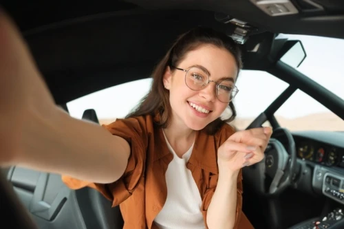 driving assistance,driving school,woman in the car,auto financing,witch driving a car,woman holding a smartphone,helicopter pilot,car rental,car communication,mobile phone car mount,driving a car,rent a car,girl in car,behind the wheel,autonomous driving,woman pointing,women in technology,coach-driving,control car,cockpit