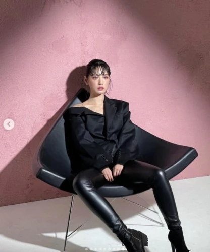 sitting on a chair,pink chair,birce akalay,seated,sofa,sitting,crossed legs,in seated position,studio photo,bolero jacket,legs crossed,vogue,cross legged,icon instagram,armchair,nylon,woman sitting,chair,black leather,leather