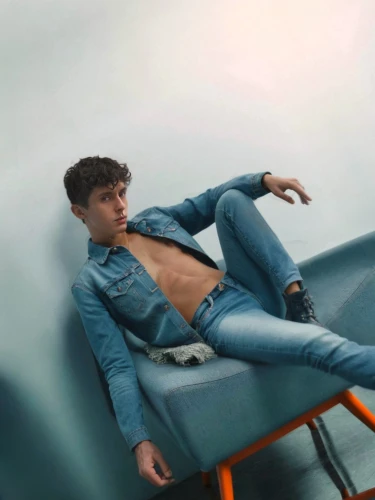 lounger,male model,blue jeans,denim jeans,denim,sunlounger,jeans background,bluejeans,cross legged,lounging,chaise,turquoise leather,abdominals,denims,baby blue,merman,shirtless,boy model,crossed legs,denim background