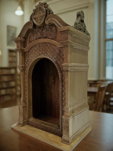 fireplace,cabinet,reading room,wood-burning stove,old library,lectern,christmas fireplace,fireplaces,miniature house,fire place,masonry oven,tabernacle,model house,library,bookcase,children's stove,scale model,knight pulpit,library book,cabinetry