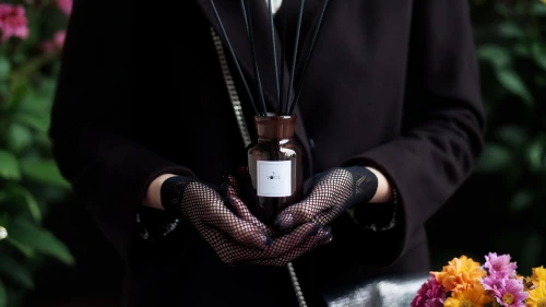 abaya,fragrance,amaryllis belladonna,tassel,ironweed,shepherd's staff,apothecary,perfume bottle,flower essences,iris,black coat,scent of jasmine,leather goods,bookmark with flowers,luxury accessories,tanacetum balsamita,concierge,common shepherd's purse,woman in menswear,fragrant