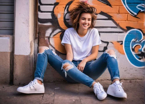 girl in t-shirt,jeans background,ripped jeans,skater,vans,sneakers,girl sitting,women clothes,denim background,jeans,concrete background,high jeans,adidas,a girl's smile,white shirt,women fashion,holding shoes,denim,white clothing,blue shoes,Photography,Documentary Photography,Documentary Photography 17