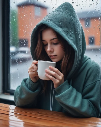 woman drinking coffee,rainy day,woman at cafe,drinking coffee,depressed woman,in the rain,tea zen,rainy,a cup of coffee,coffee background,hot coffee,hoodie,staying indoors,rainy weather,espresso,hot drink,coffee,cup of coffee,cappuccino,low poly coffee,Photography,Documentary Photography,Documentary Photography 34