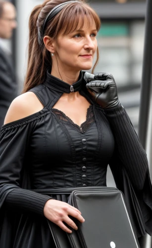 whitby goth weekend,woman holding a smartphone,woman in menswear,menswear for women,black dress with a slit,women fashion,gothic fashion,gothic dress,bussiness woman,women clothes,celtic woman,goth whitby weekend,female hollywood actress,woman walking,goth woman,black dresses,dress walk black,woman holding gun,business woman,black coat