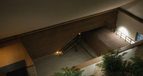 concrete ceiling,stairwell,loft,outside staircase,basement,skylight,inside courtyard,security lighting,staircase,archidaily,hallway space,exposed concrete,attic,daylighting,block balcony,winding staircase,ryokan,stairway,stairs,an apartment,Photography,General,Realistic