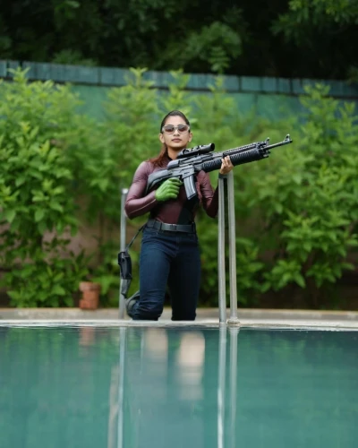 woman holding gun,girl with a gun,girl with gun,water gun,pool cleaning,rio 2016,chetna sabharwal,shooting sports,india gun,female swimmer,kamini kusum,target shooting,rifle,holding a gun,kalashnikov,airsoft gun,air gun,ammo,dug-out pool,gun