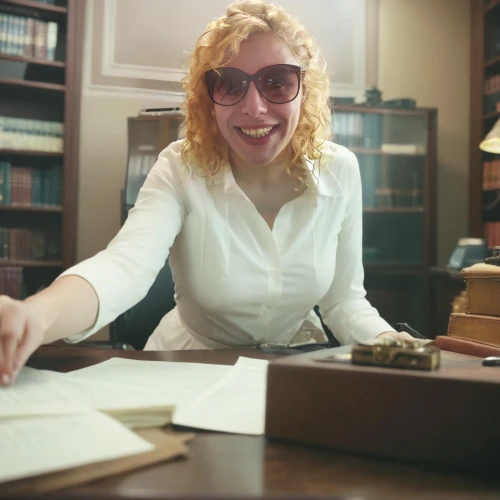 librarian,secretary,book glasses,bookkeeper,staff video,office worker,blonde woman reading a newspaper,accountant,blur office background,reading glasses,administrator,academic,real estate agent,the local administration of mastery,documents,office ruler,business woman,receptionist,silver framed glasses,businesswoman