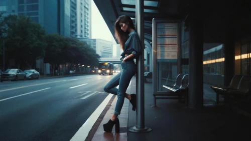bus stop,busstop,woman walking,pole dance,girl walking away,girl in a long,the girl at the station,pedestrian,long legs,on the poles,a pedestrian,conceptual photography,bus shelters,street photography,knee-high boot,taxi stand,street life,streetlife,travel woman,city ​​portrait