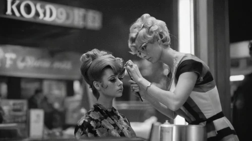 hairdresser,cigarette girl,hairstylist,applying make-up,soda shop,hair dresser,50's style,soda fountain,doll looking in mirror,beauty salon,hairdressing,retro diner,fifties,barber shop,personal grooming,hairstyler,hair care,mannequins,flapper couple,chignon