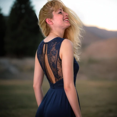 lindsey stirling,vintage dress,blue dress,girl in a long dress from the back,cocktail dress,evening dress,portrait photography,girl in a long dress,strapless dress,nice dress,country dress,a girl in a dress,dress,elegant,torn dress,blonde woman,party dress,semi-profile,day dress,long dress