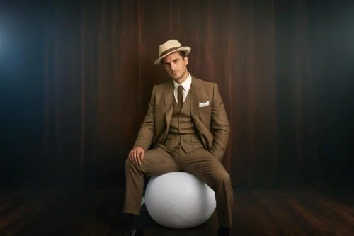 bowler hat,bellboy,a wax dummy,silver balls,men's suit,the ball,bowler,juggler,juggling,top hat,conceptual photography,magician,juggling club,armillar ball,exercise ball,suit actor,brown hat,male model,wooden balls,swiss ball