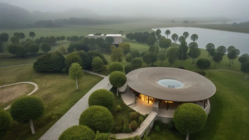 house with lake,slovenia,foggy landscape,house in mountains,aerial landscape,golf resort,eco hotel,house in the mountains,futuristic architecture,drone image,chinese architecture,round house,pool house,drone photo,bird's-eye view,drone view,beautiful home,water mist,ring fog,pilgrimage church of wies,Photography,General,Realistic