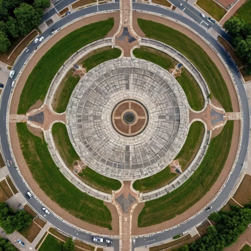 the center of symmetry,traffic circle,capitol square,jefferson monument,oval forum,circular pattern,bird's-eye view,paved square,world war ii memorial,three centered arch,view from above,thomas jefferson memorial,roundabout,aerial view umbrella,uscapitol,bird's eye view,concentric,overhead shot,granite dome,the washington monument