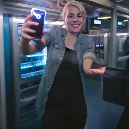 woman holding a smartphone,interactive kiosk,automated teller machine,mobile banking,payphone,wet smartphone,elevator,the girl at the station,jukebox,nokia hero,video phone,biometrics,flxible metro,pay phone,commercial,women in technology,phone booth,cellphone not allowed,vending machine,woman pointing