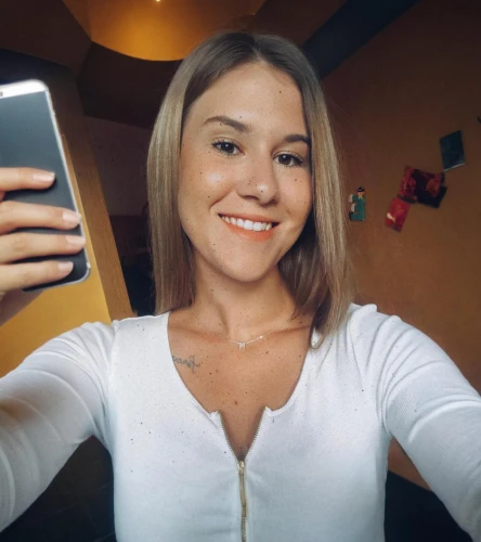blonde,iphone x,phone icon,short blond hair,smiling,instagram icon,htc,blonde girl with christmas gift,camera,holding ipad,tan,taking picture with ipad,white shirt,mobile camera,new,smiley,blonde girl,killer smile,huawei,swedish german