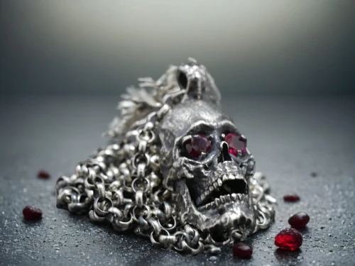 grave jewelry,vanitas,skull sculpture,gift of jewelry,dried rose,saw chain,metalsmith,silversmith,metal pile,jewelry manufacturing,cochineal,diamond pendant,body jewelry,iron chain,house jewelry,silver pieces,christmas jewelry,memento mori,chain mail,bicycle chain