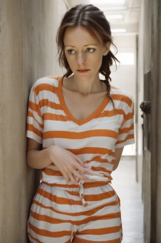 in a shirt,horizontal stripes,orange,pregnant girl,girl in t-shirt,cotton top,video scene,girl in overalls,pajamas,girl on the stairs,stripes,see-through clothing,pregnant woman,striped background,torn shirt,teen,prisoner,young woman,girl with cereal bowl,torn dress,Photography,Cinematic