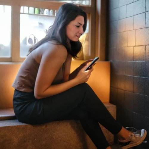woman holding a smartphone,jinglei,social media addiction,girl sitting,woman sitting,woman at cafe,rest room,on the phone,texting,asian woman,girl making selfie,messaging,chatting,japanese woman,indosat,female model,using phone,holding ipad,mobile devices,mobile banking
