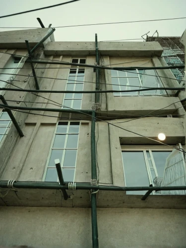 electrical wires,electrical lines,fenestration,two meters,multistory,structural glass,row of windows,old windows,wire frame,wires,hanging houses,verticalnet,glass facade,lattice windows,french windows,norilsk,transparent window,window panes,ektachrome,window frames,Photography,Documentary Photography,Documentary Photography 04