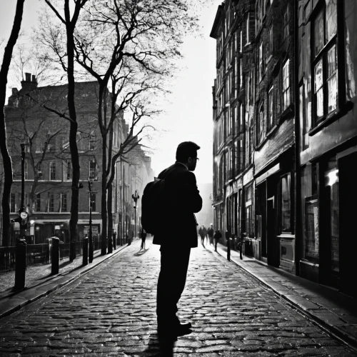 street photography,noirish,grassmarket,silhouette of man,freewheelin,cobbled,streetlife,passerby,city ​​portrait,walking man,standing man,a pedestrian,sidestreets,ianto,sidestreet,the cobbled streets,man with saxophone,spitalfields,lachaise,cobblestones,Photography,Black and white photography,Black and White Photography 01