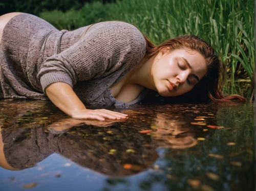 girl lying on the grass,woman laying down,ophelia,relaxed young girl,woman at the well,girl on the river,puddle,photoshoot with water,submerging,waterbed,conceptual photography,idyll,reflection in water,self hypnosis,languid,premenstrual,in water,indolence,sunken,indolent,Photography,Documentary Photography,Documentary Photography 37