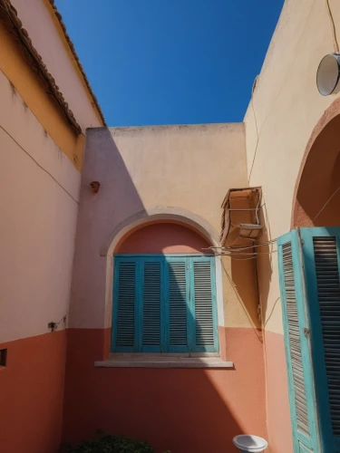 stucco frame,stucco,exterior decoration,stucco wall,cortile,courtyards,riad,window with shutters,casitas,colorful facade,roussillon,villaggio,roofline,gouna,townscapes,gold stucco frame,la kasbah,rooflines,blue doors,puglia,Photography,General,Realistic