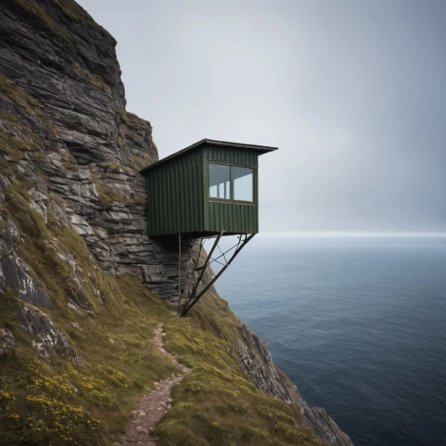 lifeguard tower,fisherman's hut,clifftop,lookout tower,cliff top,holthouse,inverted cottage,cubic house,watch tower,floating huts,cliffside,north cape,blockhouse,clifftops,observation tower,faroe islands,beach hut,watchtower,summer house,bunkhouse,Photography,Documentary Photography,Documentary Photography 38