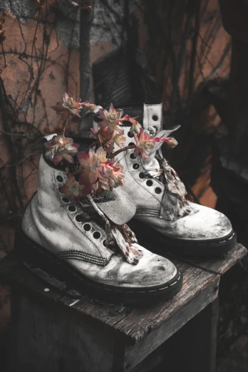 shoes on a table with flowers in the middle